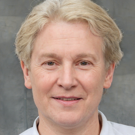 Joyful white middle-aged male with short  brown hair and grey eyes