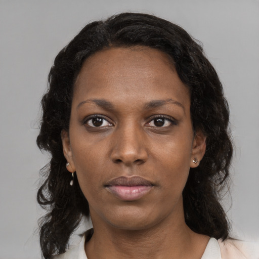 Neutral black young-adult female with medium  brown hair and brown eyes