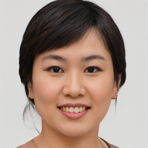 Joyful asian young-adult female with medium  brown hair and brown eyes