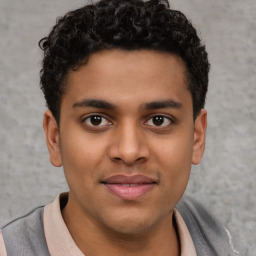 Joyful latino young-adult male with short  brown hair and brown eyes