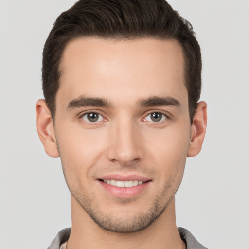 Joyful white young-adult male with short  brown hair and brown eyes