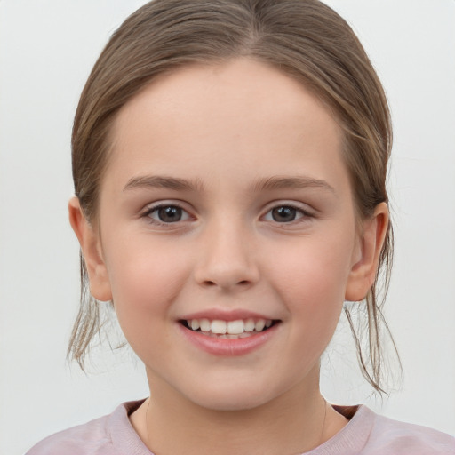 Joyful white child female with medium  brown hair and brown eyes