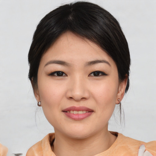 Joyful asian young-adult female with medium  black hair and brown eyes