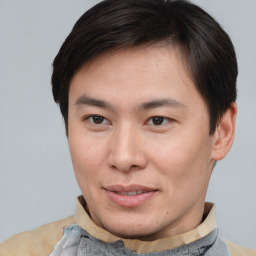 Joyful asian young-adult male with short  brown hair and brown eyes