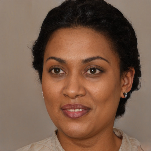Joyful black adult female with short  brown hair and brown eyes