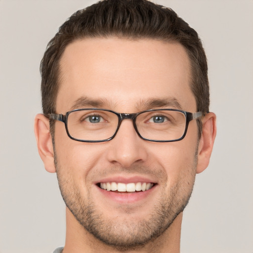 Joyful white young-adult male with short  brown hair and grey eyes