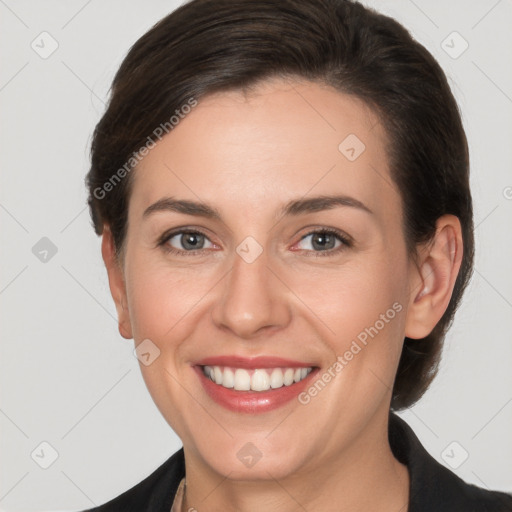 Joyful white young-adult female with short  brown hair and grey eyes