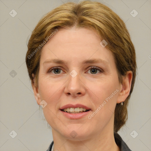 Joyful white adult female with medium  brown hair and brown eyes