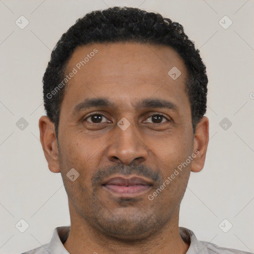 Neutral latino adult male with short  black hair and brown eyes