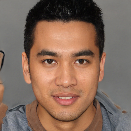 Joyful asian young-adult male with short  brown hair and brown eyes