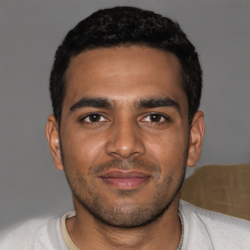 Joyful black young-adult male with short  brown hair and brown eyes