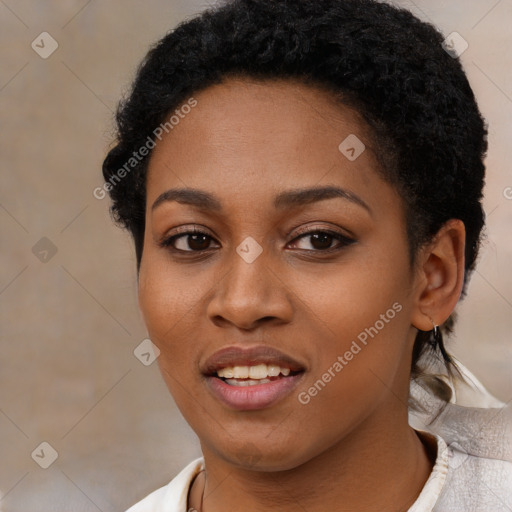 Joyful black young-adult female with short  black hair and brown eyes