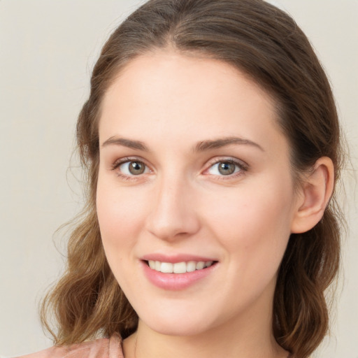 Joyful white young-adult female with medium  brown hair and green eyes