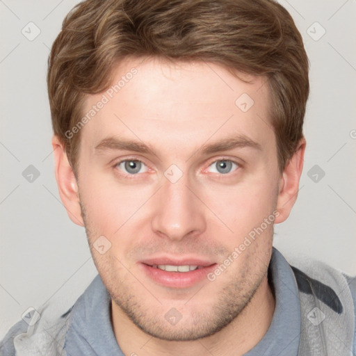 Joyful white young-adult male with short  brown hair and blue eyes