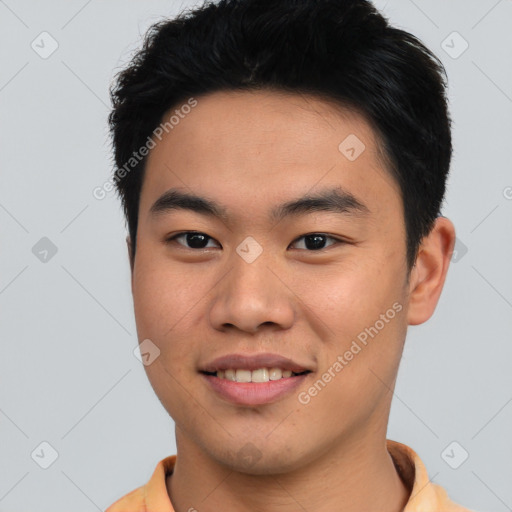 Joyful asian young-adult male with short  black hair and brown eyes