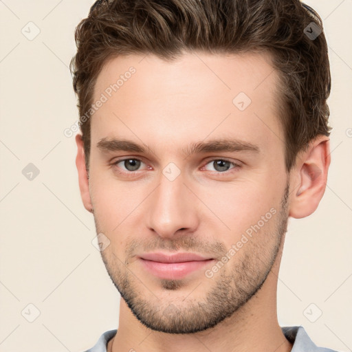 Joyful white young-adult male with short  brown hair and brown eyes