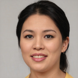 Joyful asian young-adult female with medium  brown hair and brown eyes