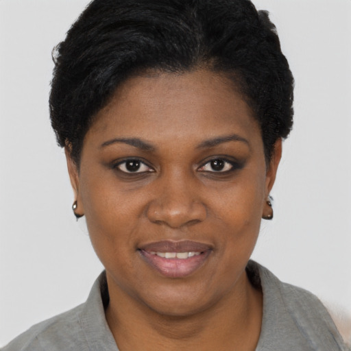 Joyful black young-adult female with short  black hair and brown eyes