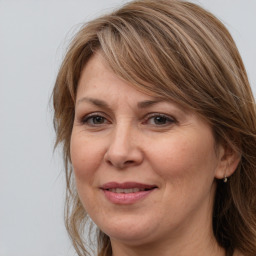 Joyful white adult female with medium  brown hair and grey eyes