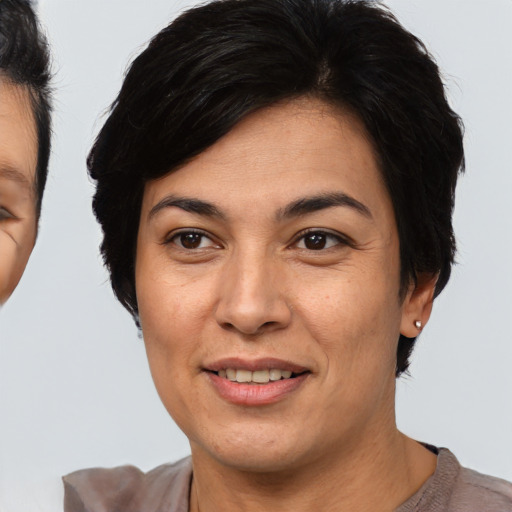 Joyful asian adult female with short  brown hair and brown eyes