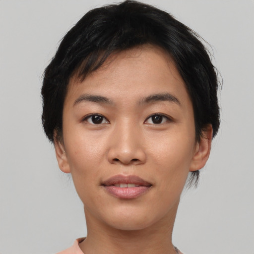 Joyful asian young-adult female with short  black hair and brown eyes