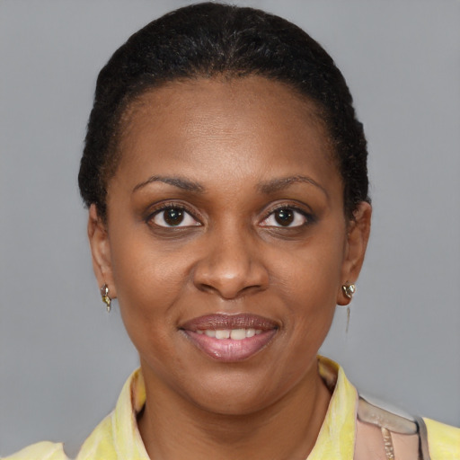 Joyful black young-adult female with short  brown hair and brown eyes