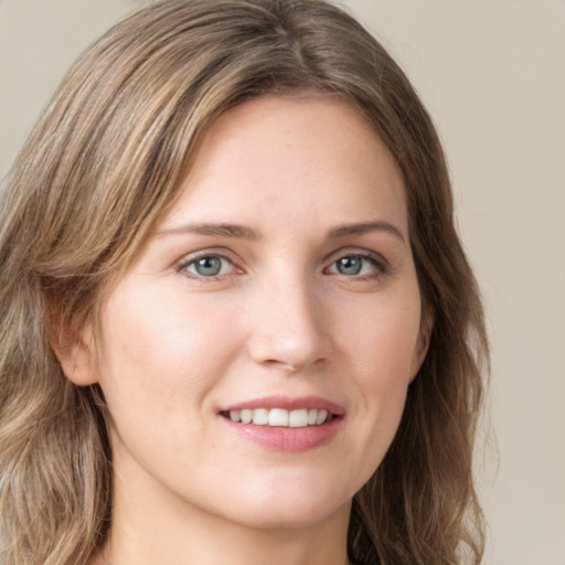 Joyful white young-adult female with long  brown hair and green eyes