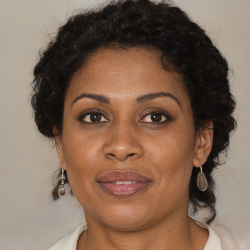 Joyful black young-adult female with medium  brown hair and brown eyes