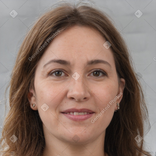 Joyful white adult female with long  brown hair and brown eyes