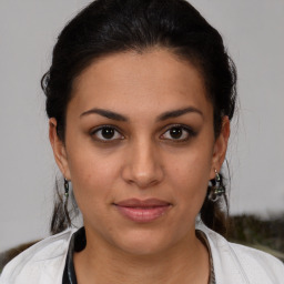 Joyful latino young-adult female with short  brown hair and brown eyes