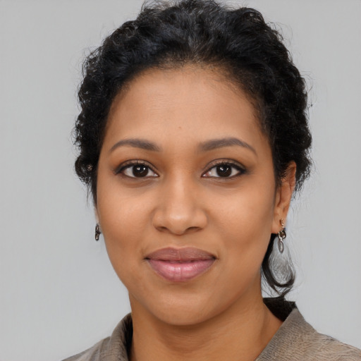Joyful latino young-adult female with short  black hair and brown eyes