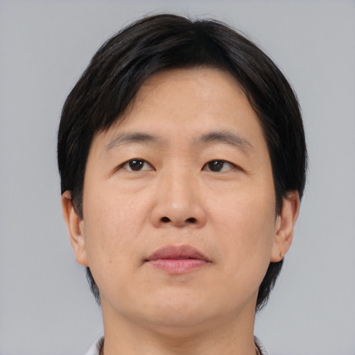 Neutral asian adult male with short  brown hair and brown eyes