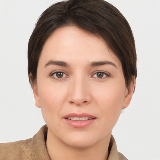 Joyful white young-adult female with short  brown hair and brown eyes