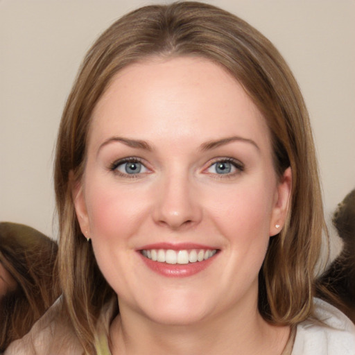 Joyful white young-adult female with medium  brown hair and grey eyes