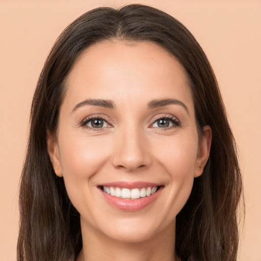 Joyful white young-adult female with long  brown hair and brown eyes