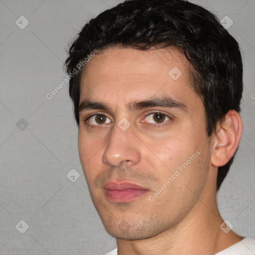 Joyful white young-adult male with short  black hair and brown eyes