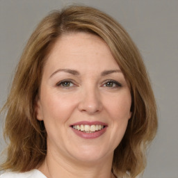 Joyful white adult female with medium  brown hair and brown eyes