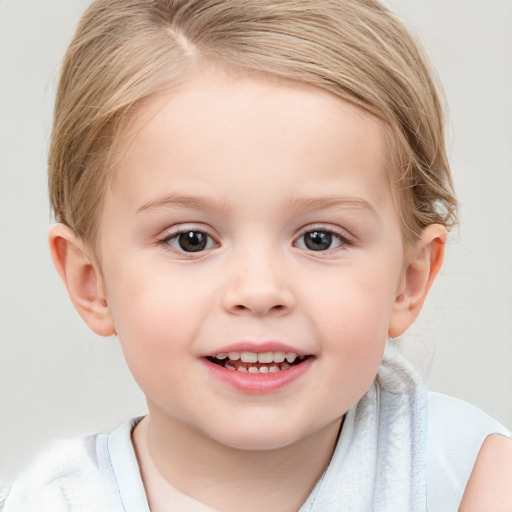 Joyful white child female with short  brown hair and blue eyes