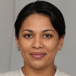 Joyful latino young-adult female with short  brown hair and brown eyes