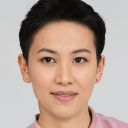 Joyful asian young-adult female with short  black hair and brown eyes