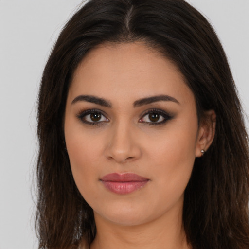 Joyful latino young-adult female with long  brown hair and brown eyes