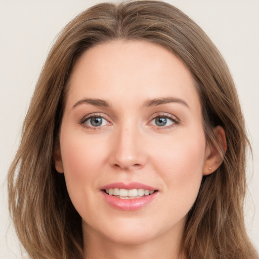 Joyful white young-adult female with long  brown hair and blue eyes