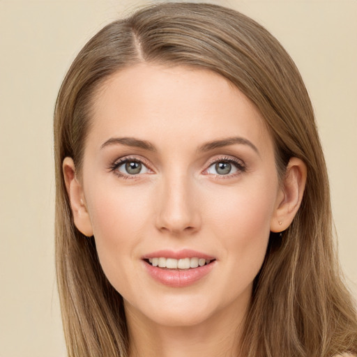 Joyful white young-adult female with long  brown hair and brown eyes