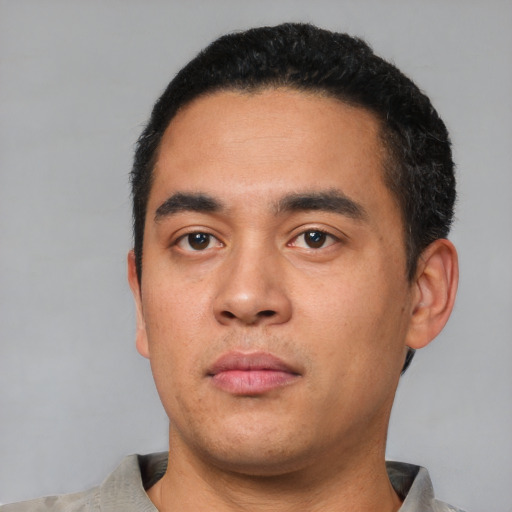 Neutral latino young-adult male with short  black hair and brown eyes