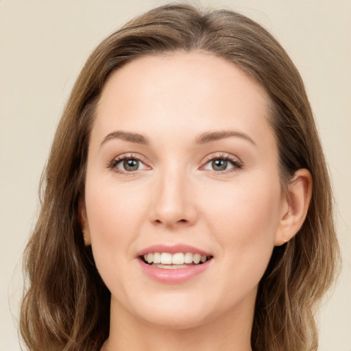 Joyful white young-adult female with medium  brown hair and green eyes