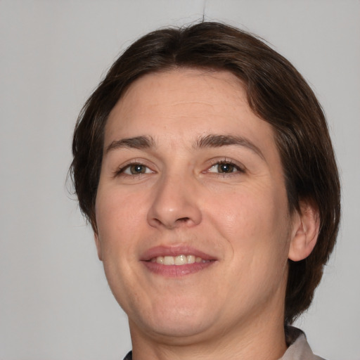 Joyful white adult male with medium  brown hair and brown eyes