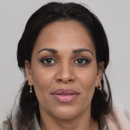 Joyful black adult female with medium  brown hair and brown eyes