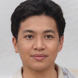 Joyful asian young-adult male with short  brown hair and brown eyes