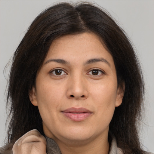 Joyful white adult female with medium  brown hair and brown eyes