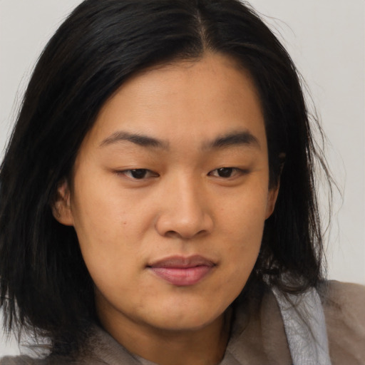 Joyful asian young-adult female with medium  black hair and brown eyes